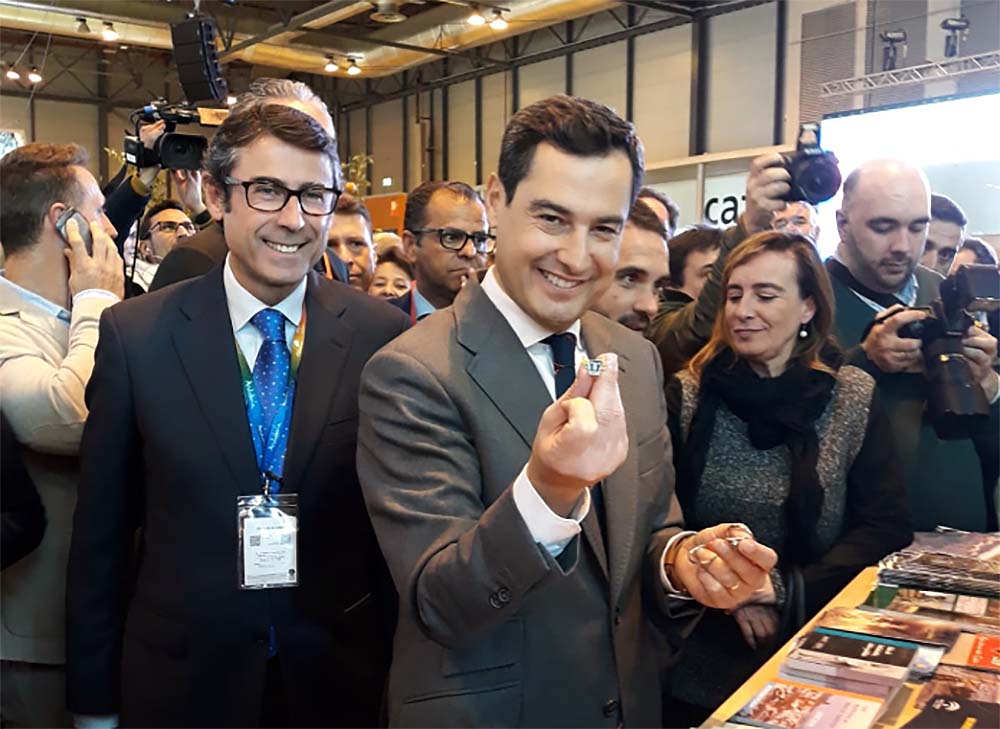 Juanma Moreno se hace una foto en Fitur con el logo de Turismo Ronda.