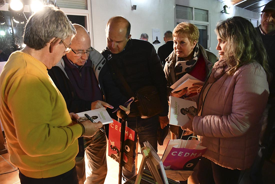 El autor firmando libros a algunos de sus lectores en el acto de presentación de la obra,