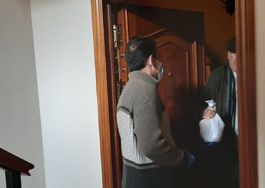 Un trabajador de Bienestar Social realiza una entrega a un mayor rondeño que no puede salir de su domicilio.
