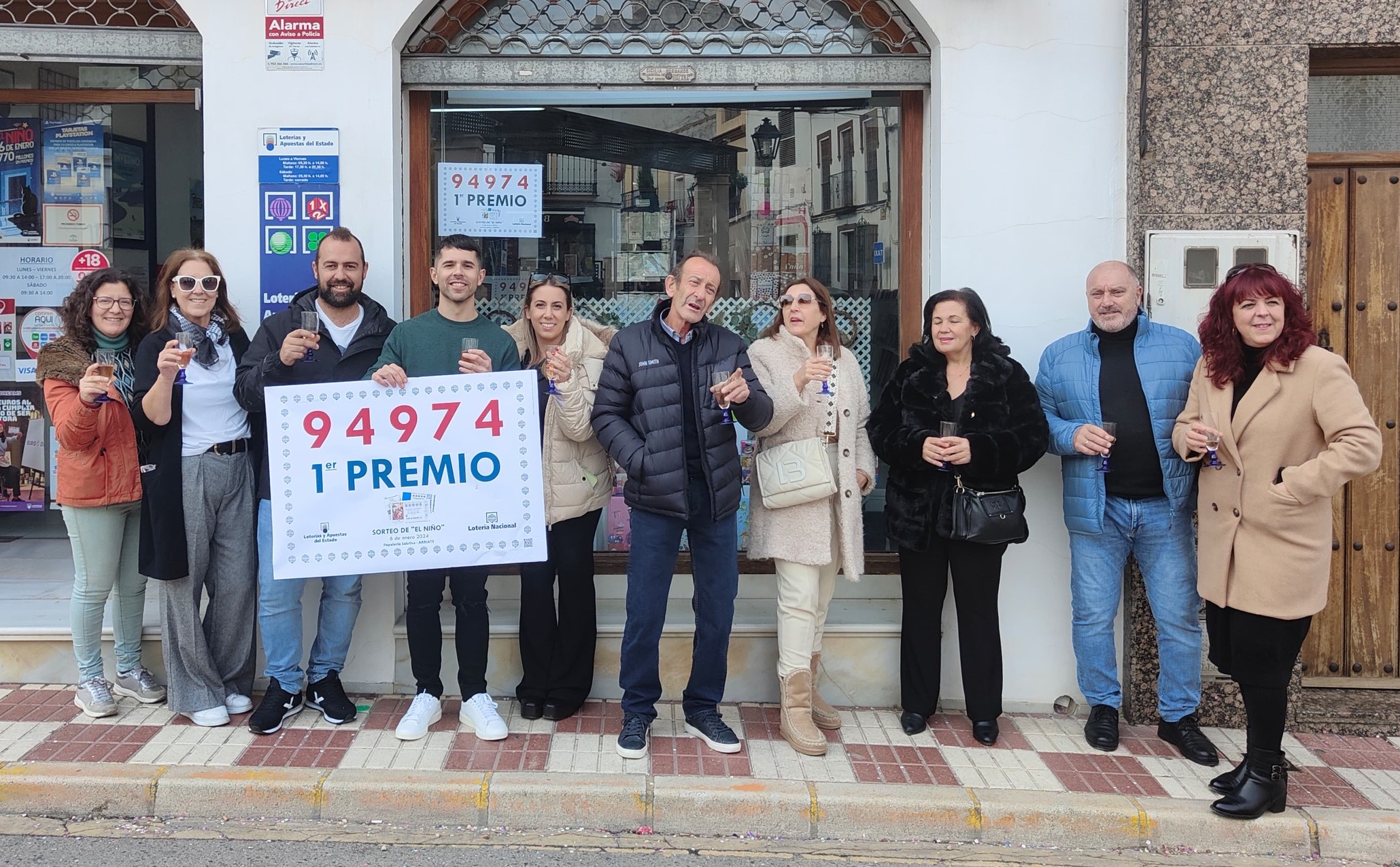El vendedor y algunos vecinos celebran el premio que ha caído en Arriate. Foto Arriate Online.