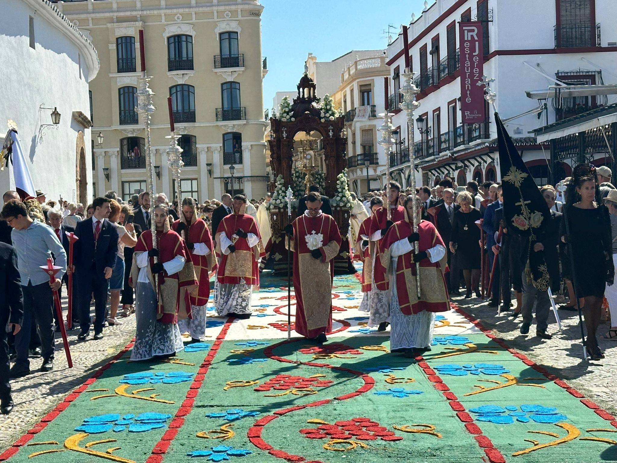 Momento en el que el Santísimo Sacramento pasa por la alfombra floral.
